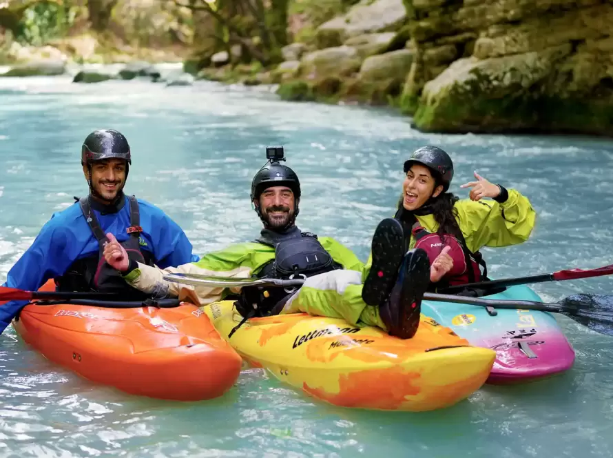 Three kayakers pose for a fun picture