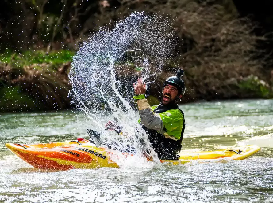 A person has fun kayaking in Greece.