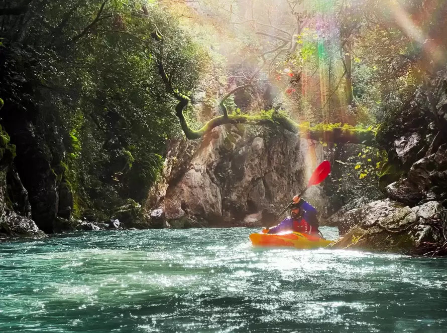 A person kayaks in a river in Greece.