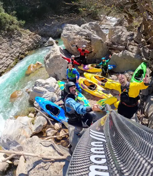 Kayakers bring their kayaks down a mountain in Greece.