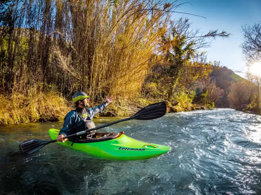 A person kayaks in a river in Greece.