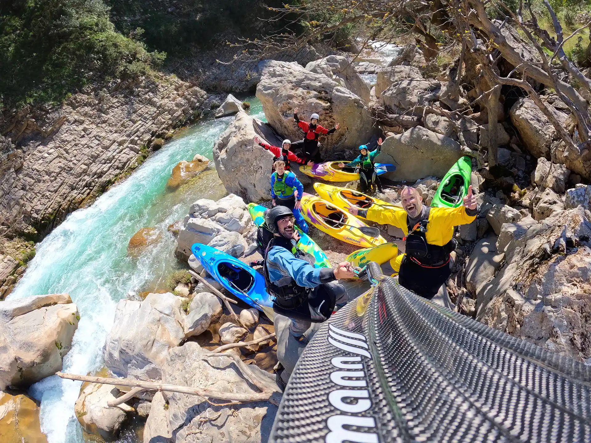 Kayakers bring their kayaks down a mountain in Greece.