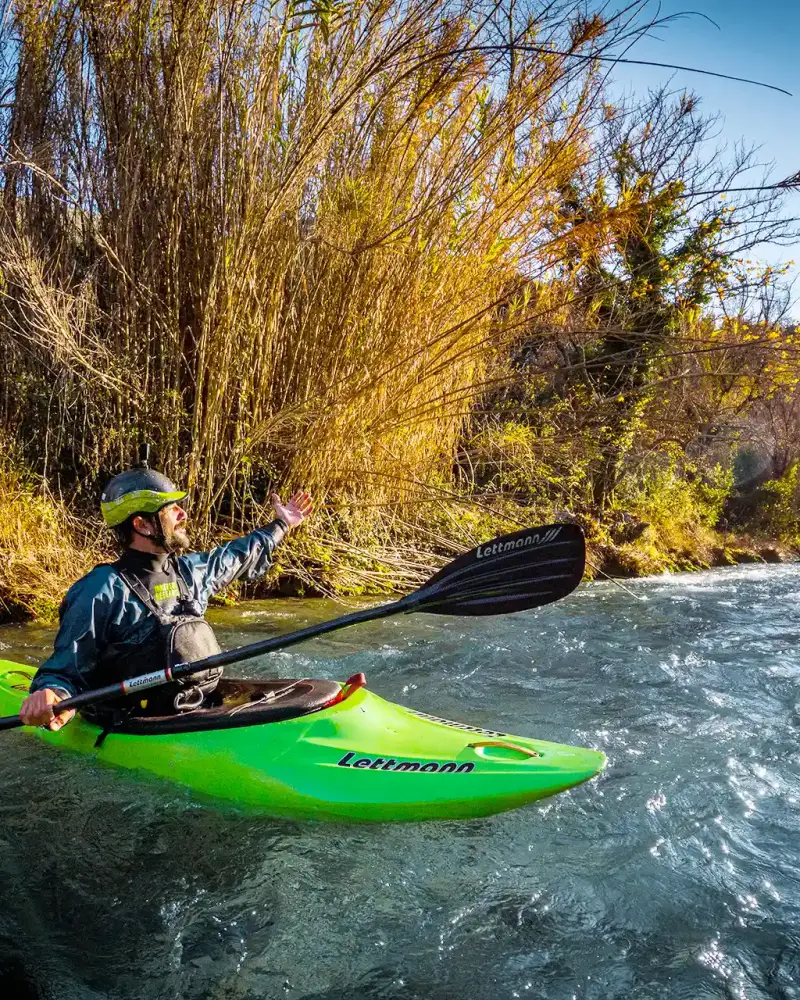 A person kayaks in a river in Greece.
